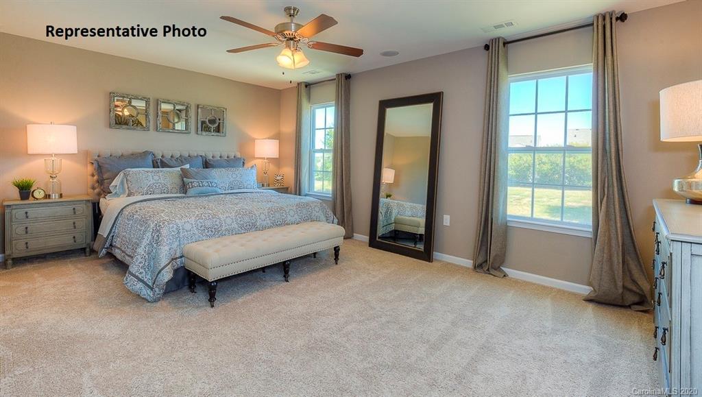 7261 Finnigan Road Charlotte, NC 28215 - Photo 32 of 40 a spacious bedroom with a bed and a large window