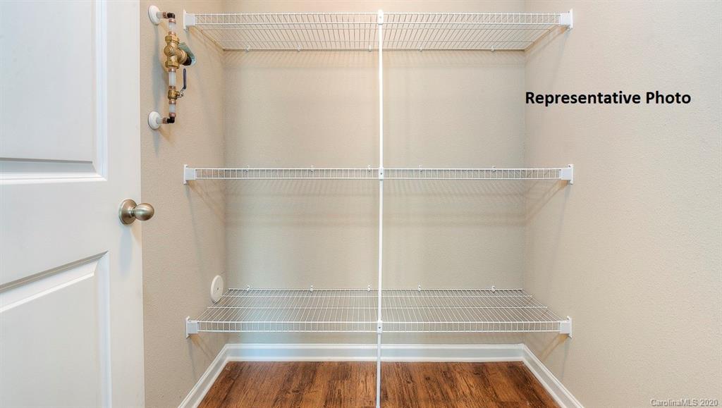7261 Finnigan Road Charlotte, NC 28215 - Photo 37 of 40 a view of walk in closet with empty racks