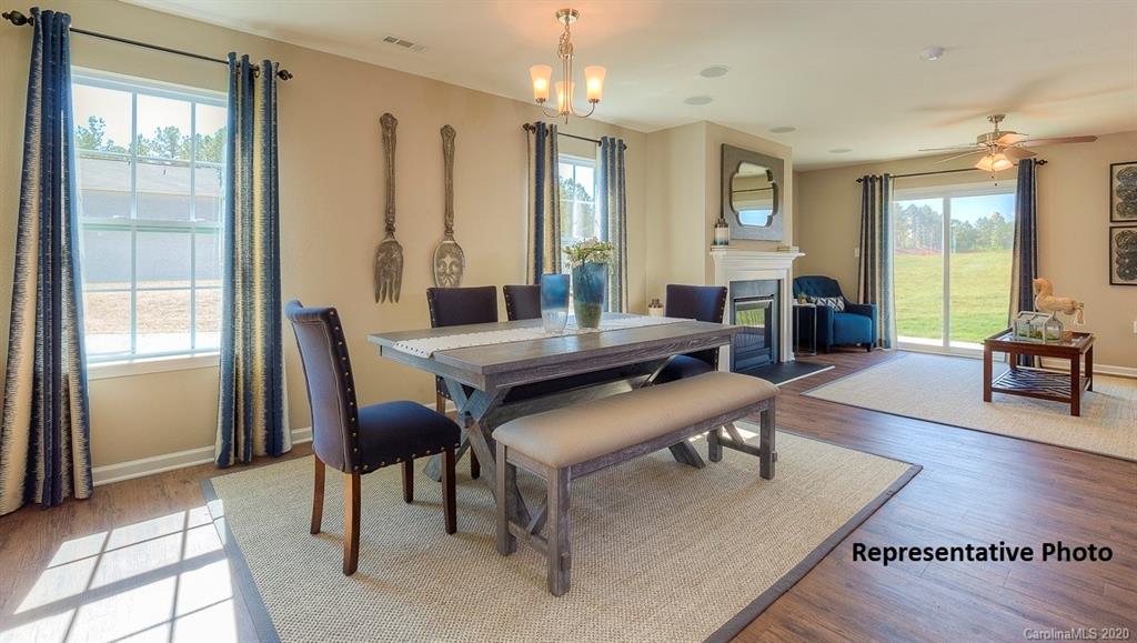 7261 Finnigan Road Charlotte, NC 28215 - Photo 5 of 40 a living room with furniture a large window and wooden floor