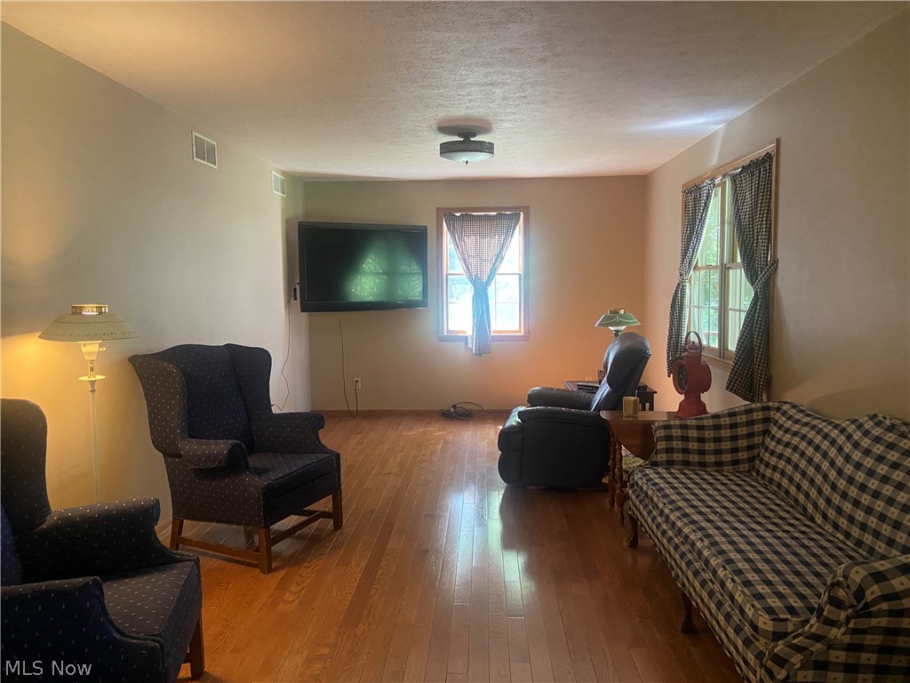 2445 South Elyria Road Wooster, OH 44691 - Photo 15 of 46 Sitting room featuring hardwood / wood-style flooring and a textured ceiling