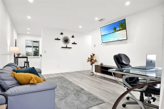 a living room with furniture and wooden floor