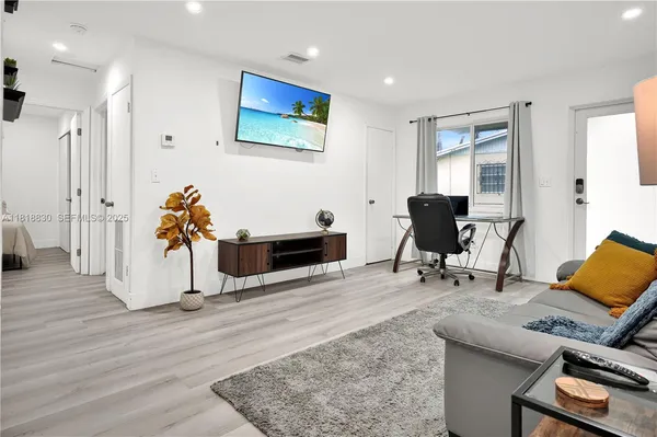 a living room with furniture a rug and a fireplace