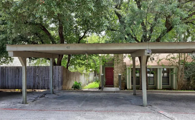a backyard of a house with barbeque oven table and chairs