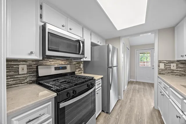 a kitchen with a stove and a microwave