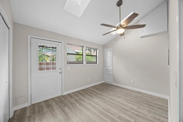 wooden floor in an empty room with a window