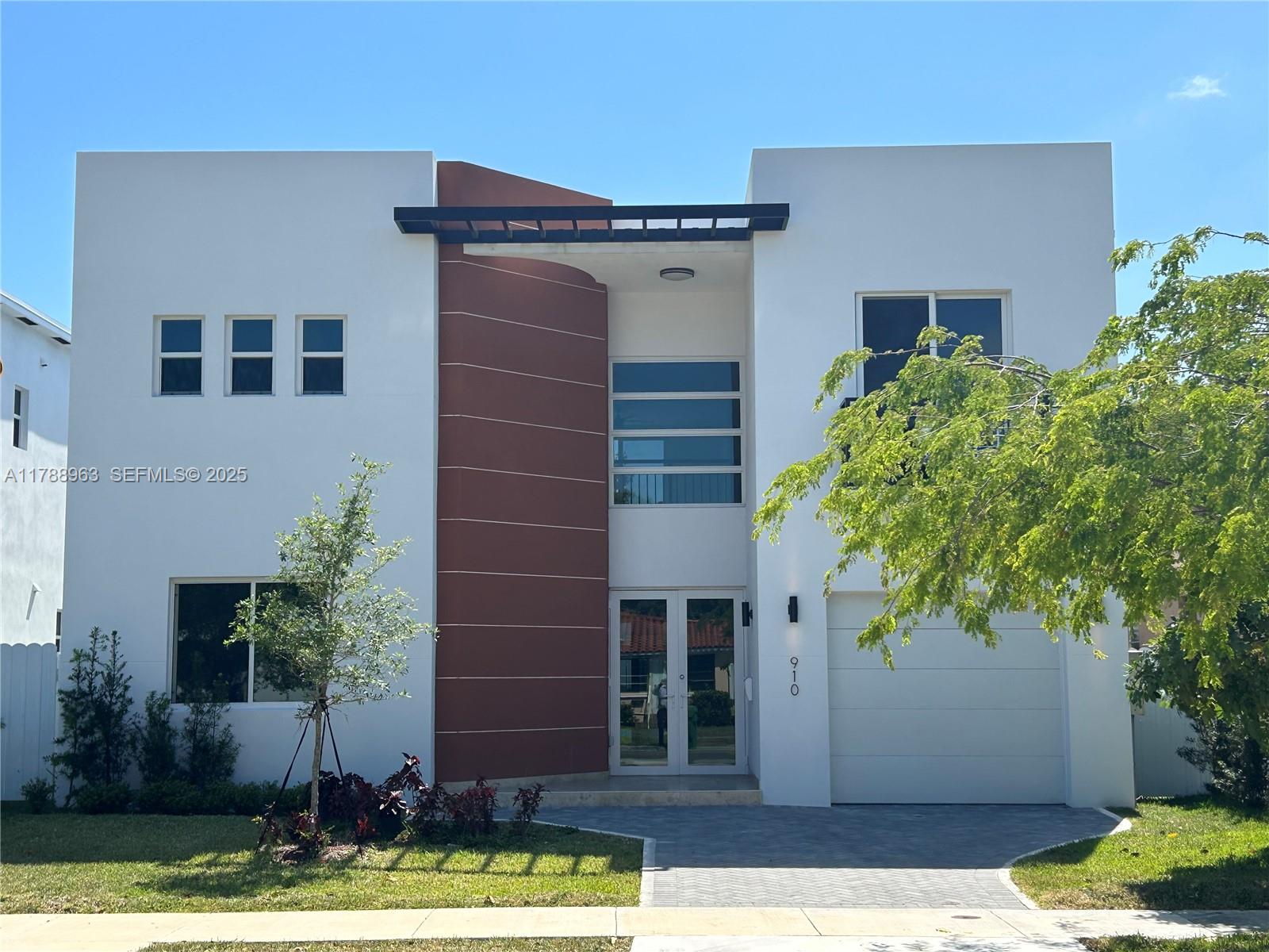 910 Southwest 24th Road Miami, FL 33129 - Photo 1 of 38 a front view of a house with garden