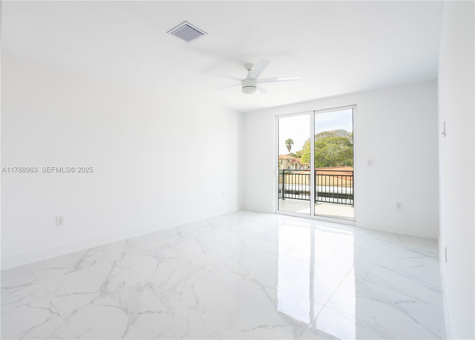 910 Southwest 24th Road Miami, FL 33129 - Photo 18 of 38 an empty room with a ceiling fan and a window