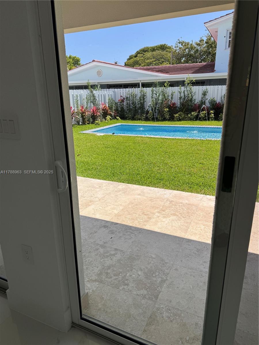 910 Southwest 24th Road Miami, FL 33129 - Photo 19 of 38 a view of a room with a bed and a floor to ceiling window