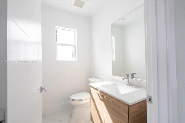 a spacious bathroom with a double vanity sink a mirror and a bathtub