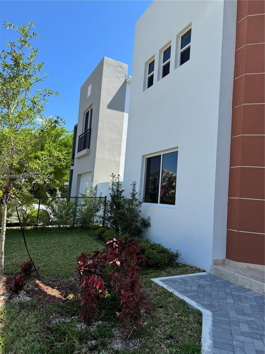 910 Southwest 24th Road Miami, FL 33129 - Photo 34 of 38 a garden with a bench in front of the house