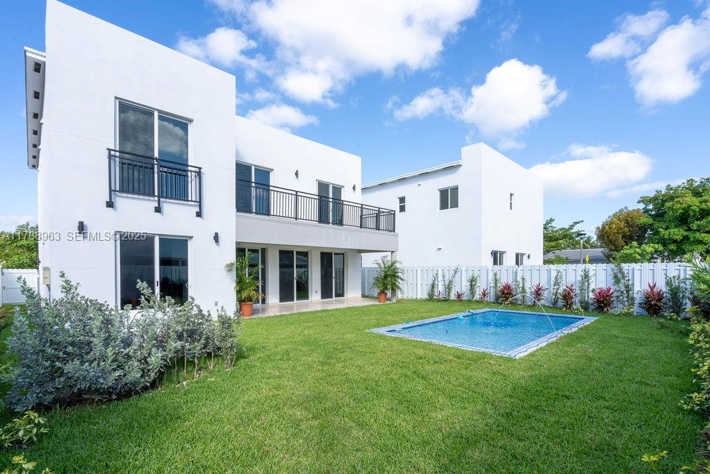910 Southwest 24th Road Miami, FL 33129 - Photo 4 of 38 a view of a white house with a big yard and large trees