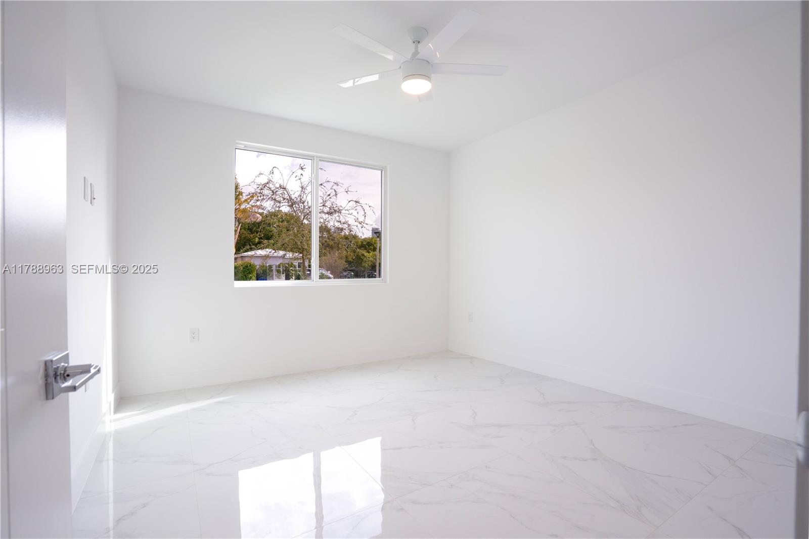 910 Southwest 24th Road Miami, FL 33129 - Photo 5 of 38 an empty room with a window