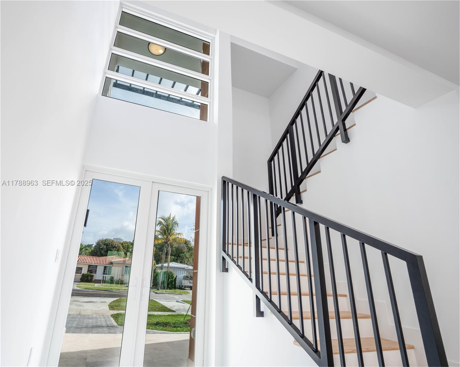 910 Southwest 24th Road Miami, FL 33129 - Photo 8 of 38 a view of staircase with railing and a window
