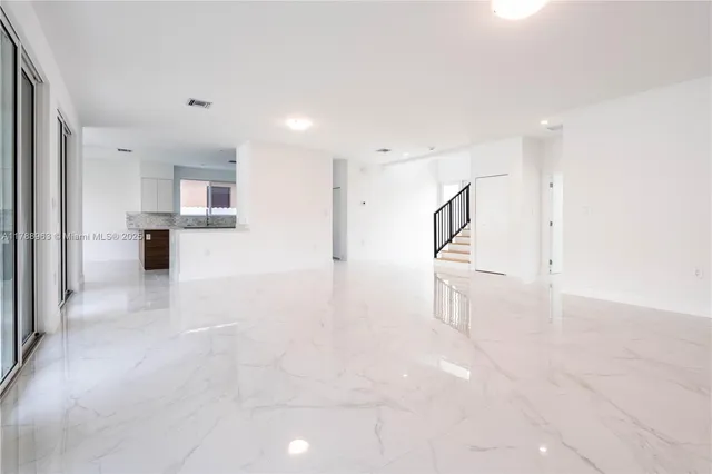 a view of a staircase with white walls