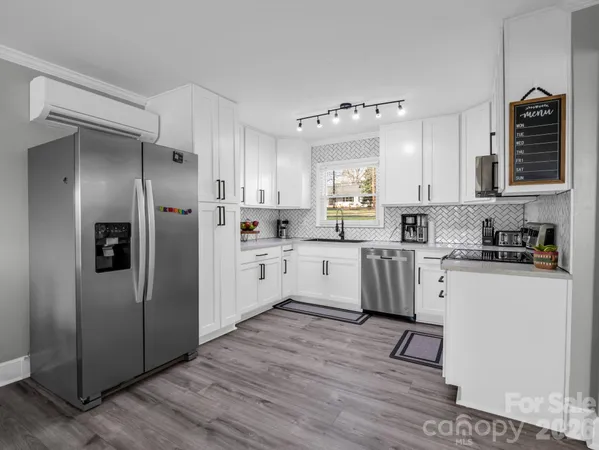 a kitchen with white cabinets and white appliances