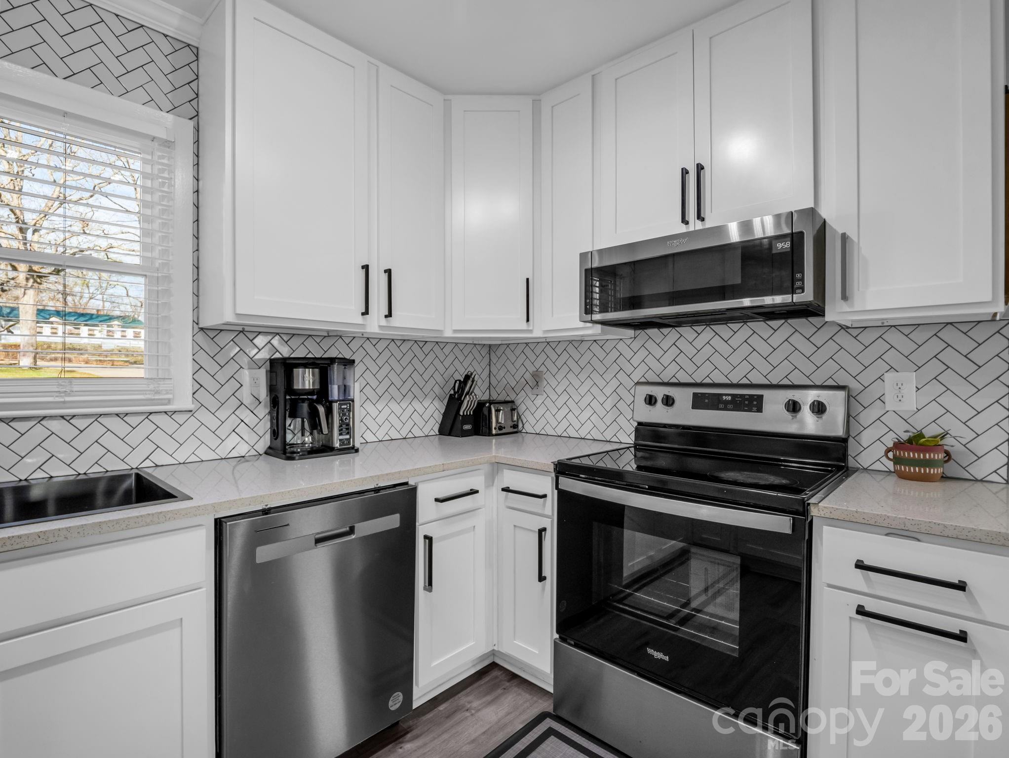151 South Main Street Bostic, NC 28018 - Photo 20 of 45 a kitchen with granite countertop a stove sink and microwave