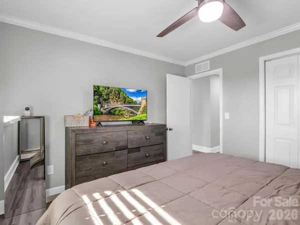 a bedroom with a bed and a dresser