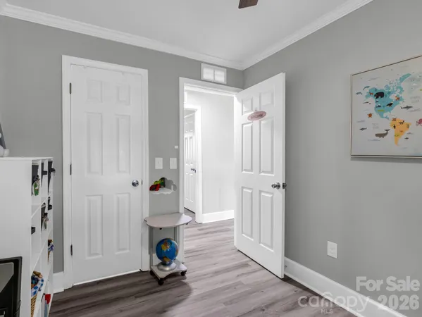 a room that has a painting on the wall and a wooden floor