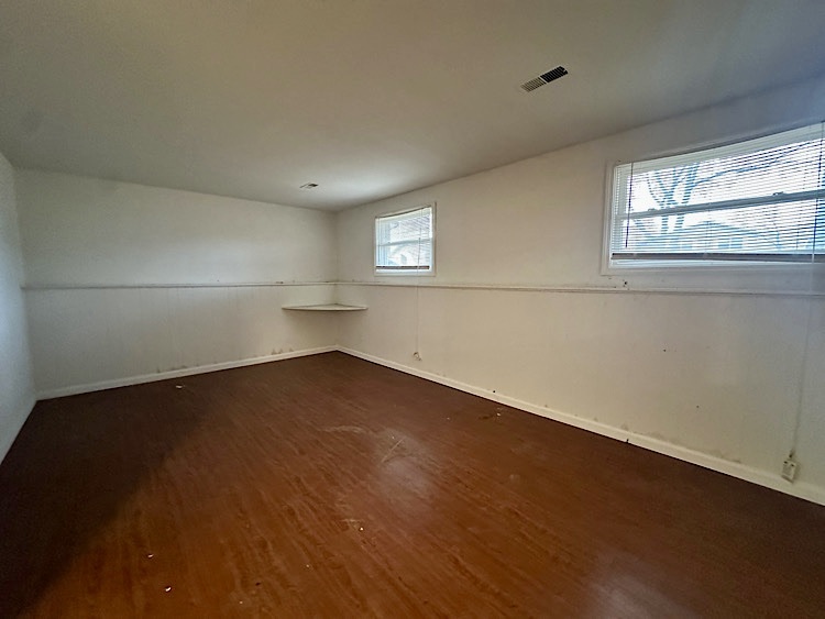 7777 Ramsgate Circle South Hanover Park, IL 60133 - Photo 20 of 26 an empty room with wooden floor and windows
