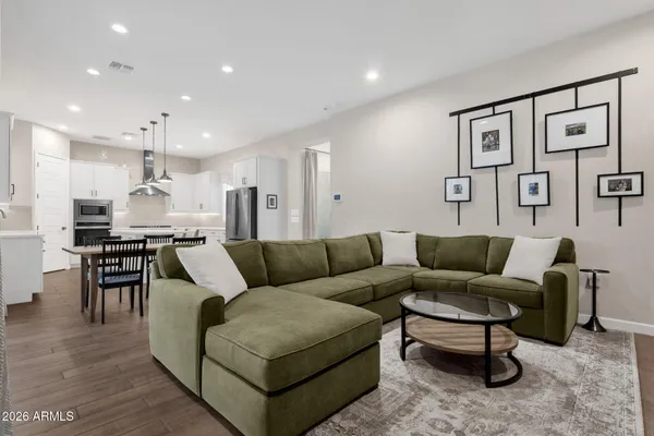 a living room with furniture kitchen view and a dining table