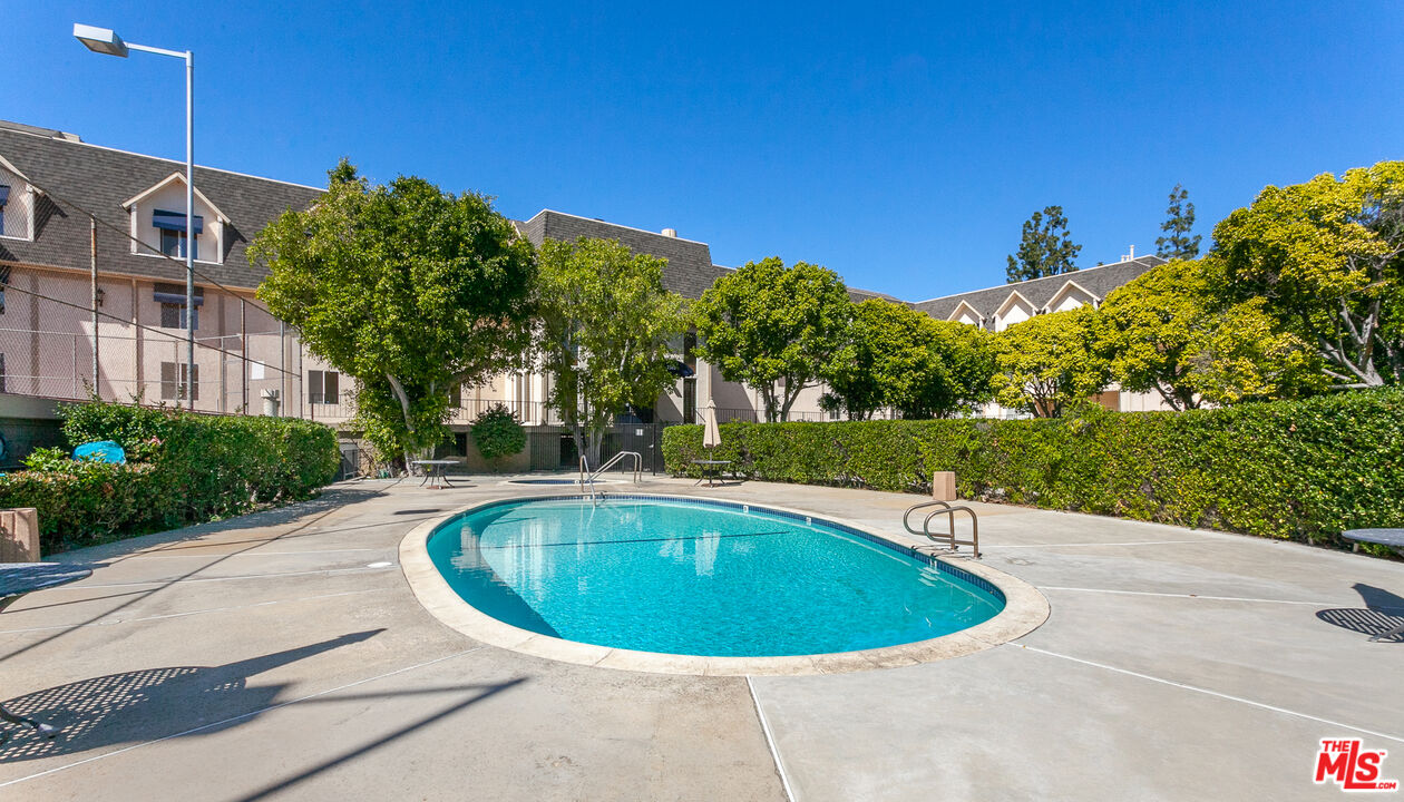 2385 Roscomare Road, Unit D17 Los Angeles, CA 90077 - Photo 16 of 18 a view of a swimming pool with a yard