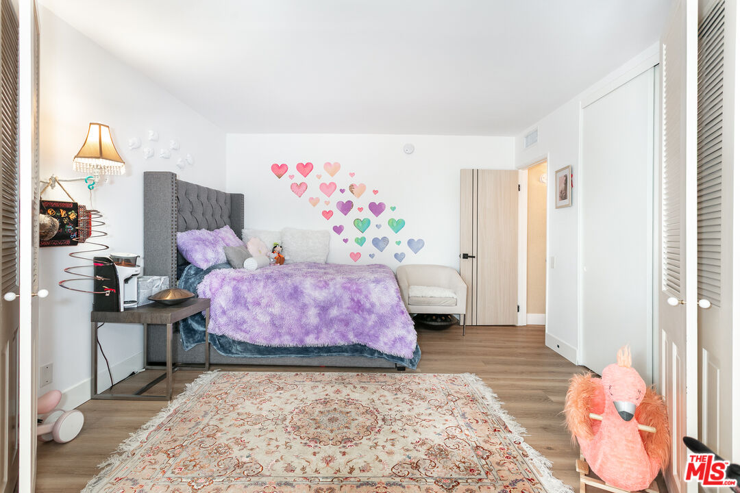 2385 Roscomare Road, Unit D17 Los Angeles, CA 90077 - Photo 5 of 18 a bedroom with furniture and a wooden floor