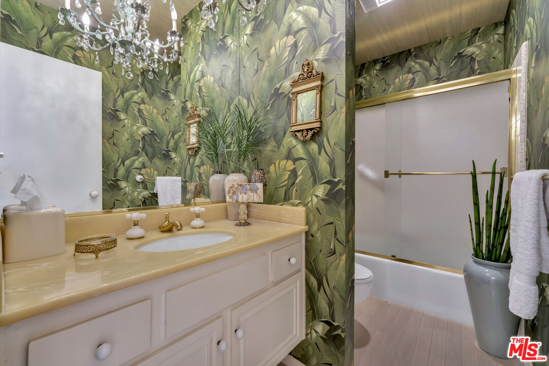 2385 Roscomare Road, Unit D17 Los Angeles, CA 90077 - Photo 7 of 18 a bathroom with a granite countertop sink a toilet and a shower