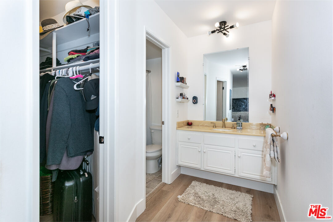2385 Roscomare Road, Unit D17 Los Angeles, CA 90077 - Photo 10 of 18 a bathroom with a double vanity sink and a mirror