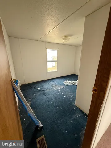 a room with furniture a flat screen tv and a window