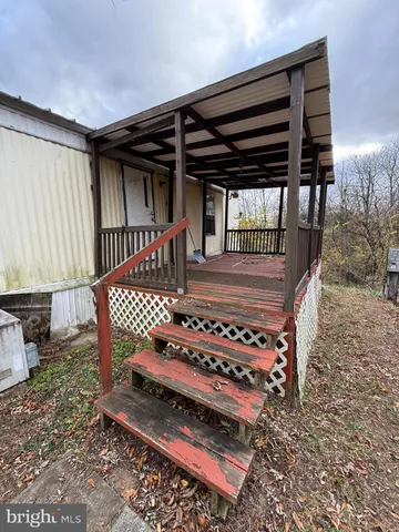 a view of a chairs and tables in the back yard of the house