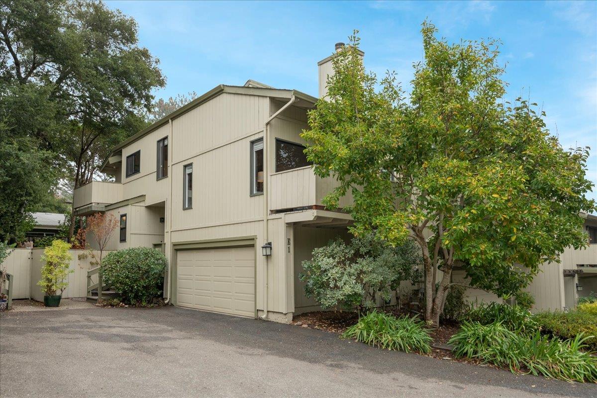 146 Bean Creek Road, Unit E1 Scotts Valley, CA 95066 - Photo 1 of 17 a view of a white house with a large tree and plants