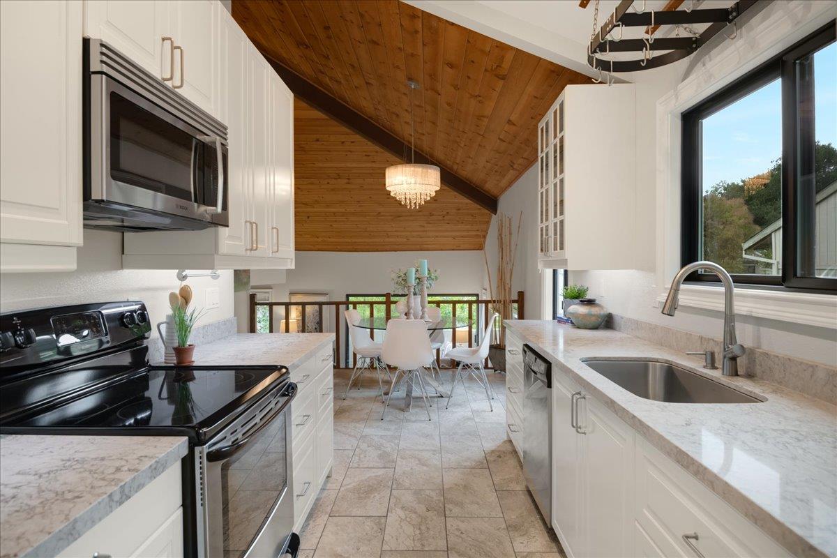 146 Bean Creek Road, Unit E1 Scotts Valley, CA 95066 - Photo 5 of 17 a kitchen with stainless steel appliances granite countertop a sink stove and microwave