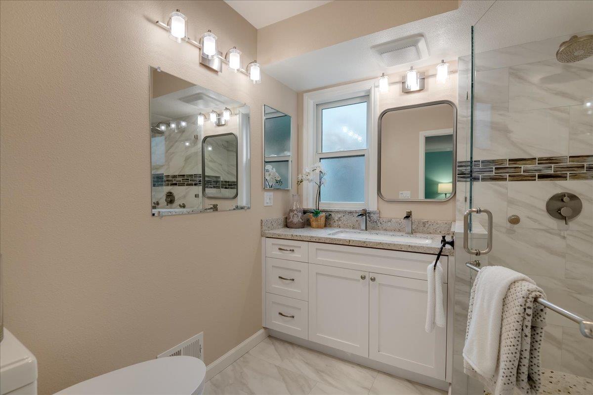 146 Bean Creek Road, Unit E1 Scotts Valley, CA 95066 - Photo 9 of 17 a bathroom with a toilet sink and mirror