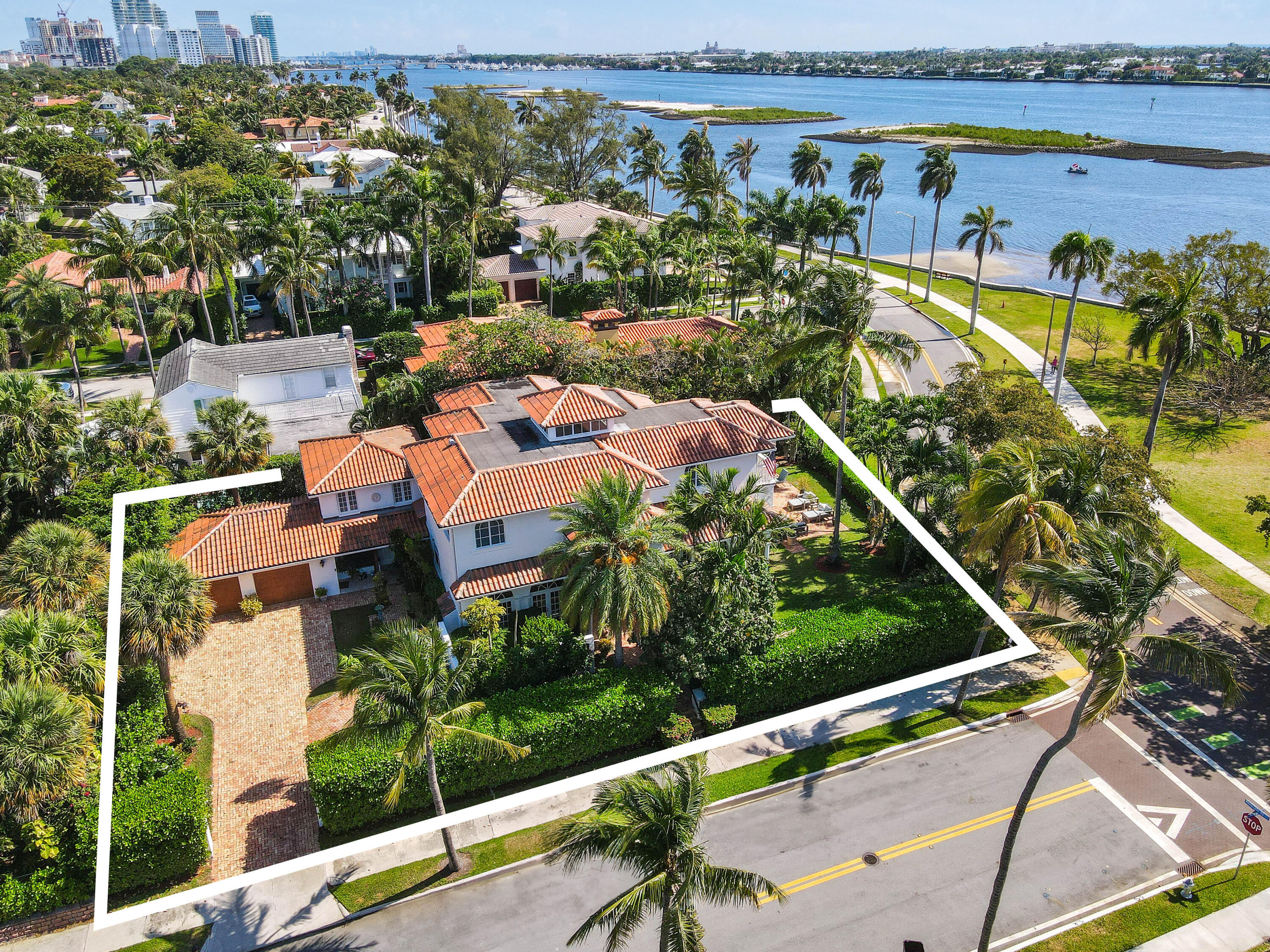 an aerial view of a house with a garden and lake view