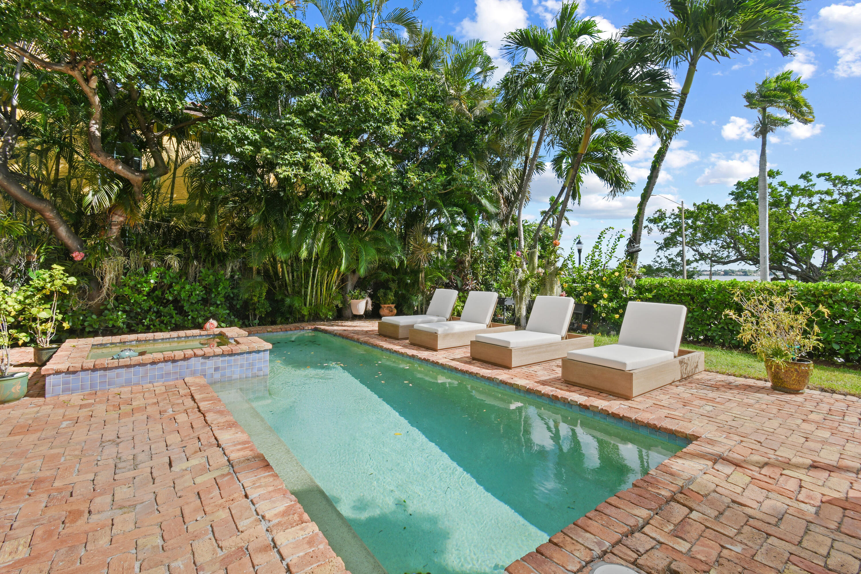 201 Avila Road West Palm Beach, FL 33405 - Photo 60 of 75 a view of a patio with dining table and chairs with a fire pit