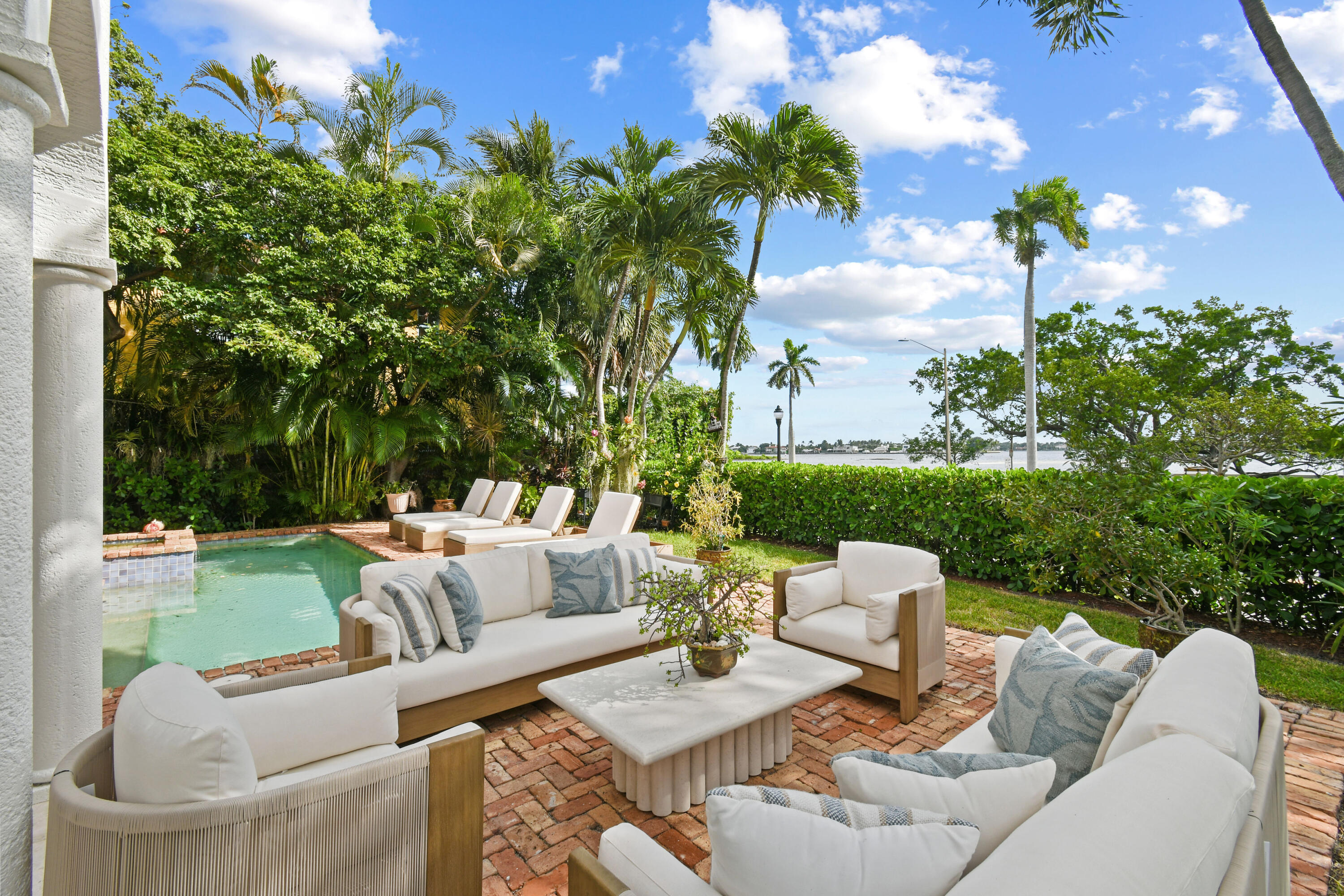 201 Avila Road West Palm Beach, FL 33405 - Photo 62 of 75 a view of a patio with couches table and chairs and potted plants