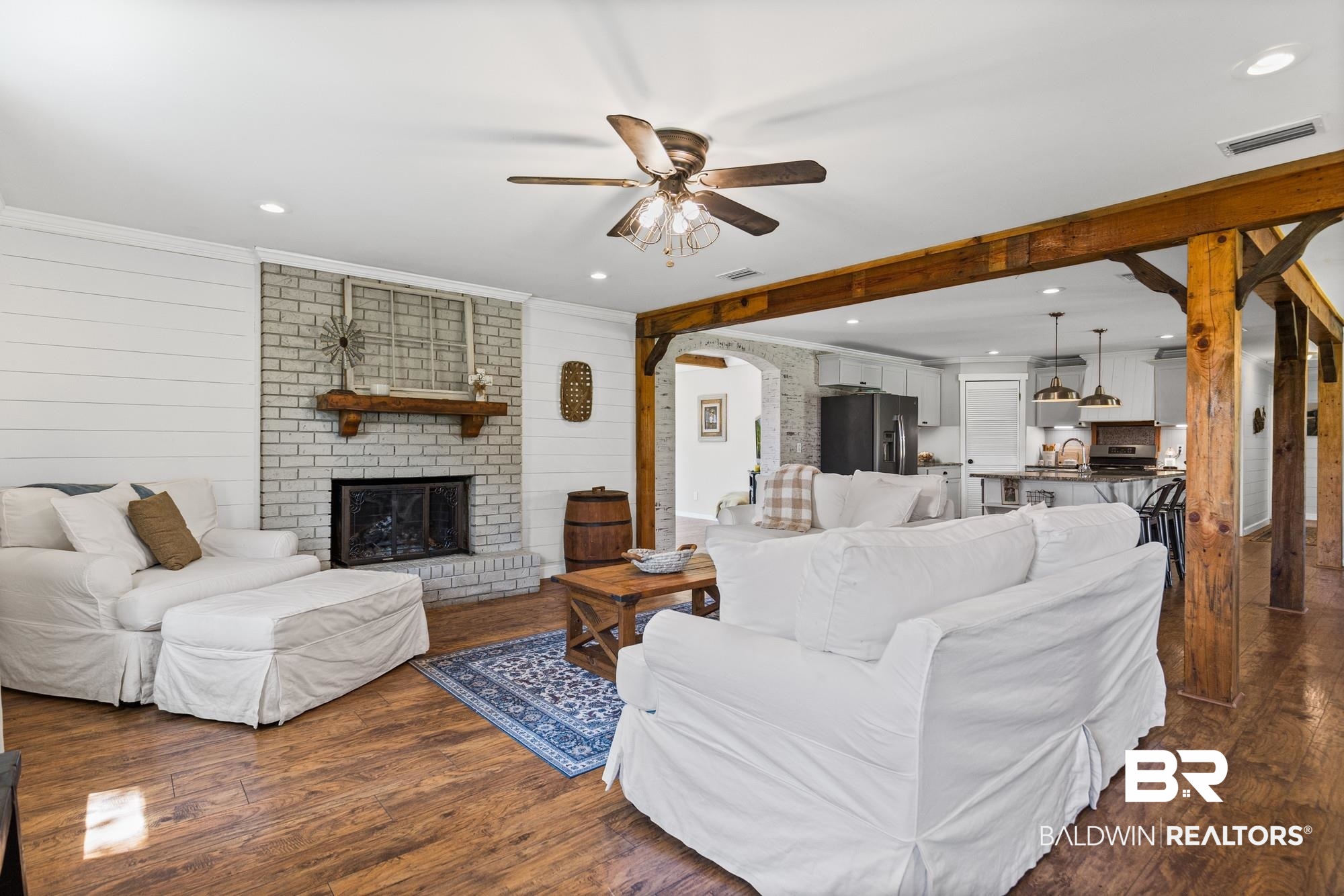11100 Rhett McConnell Road Theodore, AL 36582 - Photo 5 of 47 Living room with arched walkways, dark wood finished floors, a ceiling fan, a fireplace, and recessed lighting
