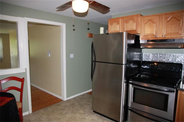 297 Morgan Road West Springfield, MA 01089 - Photo 4 of 19 a kitchen with stainless steel appliances granite countertop a refrigerator a stove and a sink with wooden floor