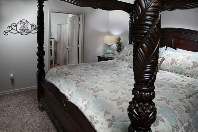 a bedroom with a bed and a chandelier