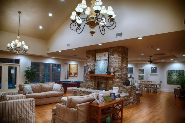 a living room with fireplace furniture and a chandelier