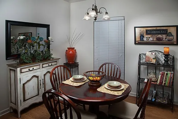a view of a dining room with furniture and wooden floor