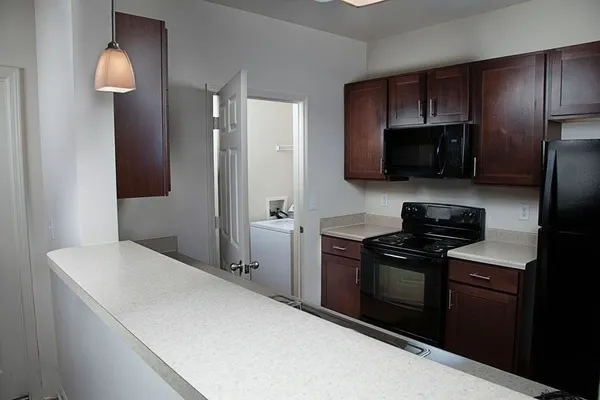 a kitchen with a refrigerator stove and microwave
