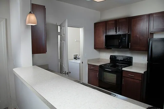 a kitchen with a refrigerator stove and microwave