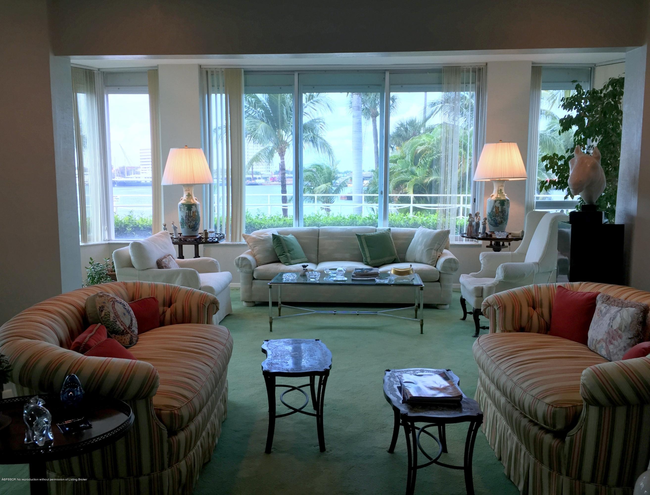 44 Cocoanut Row, Unit 115B Palm Beach, FL 33480 - Photo 1 of 4 a living room with furniture and a large window