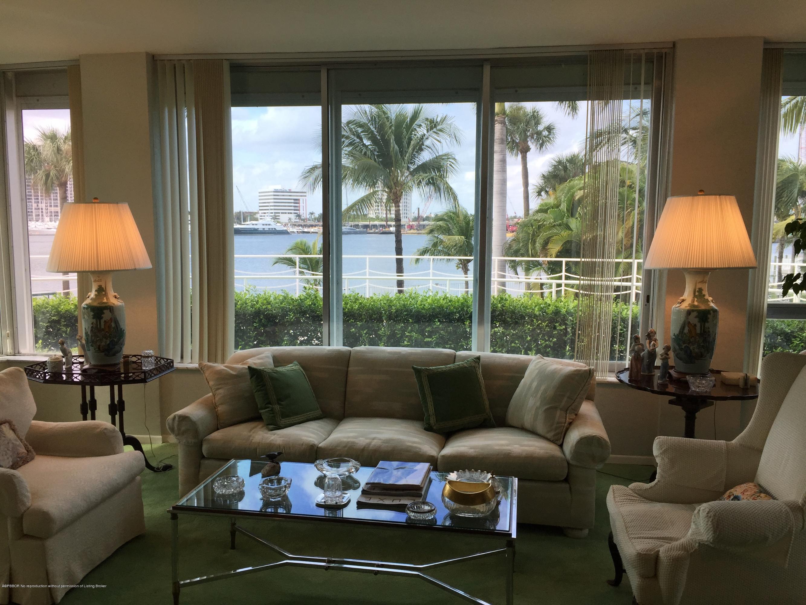 44 Cocoanut Row, Unit 115B Palm Beach, FL 33480 - Photo 2 of 4 a living room with furniture and a lamp