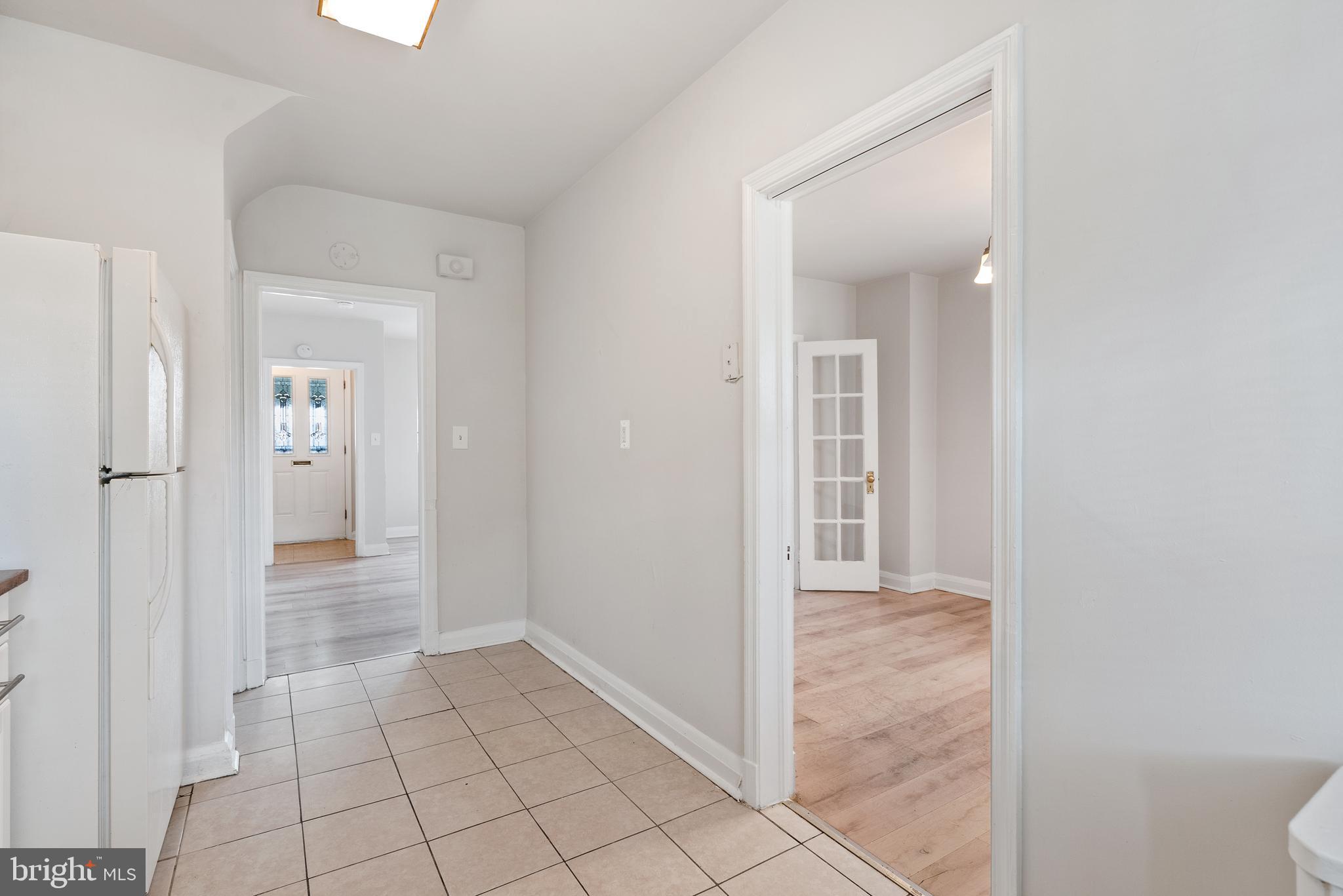 1617 Northwick Road Baltimore, MD 21218 - Photo 20 of 32 a view of a hallway with wooden floor and a bathroom