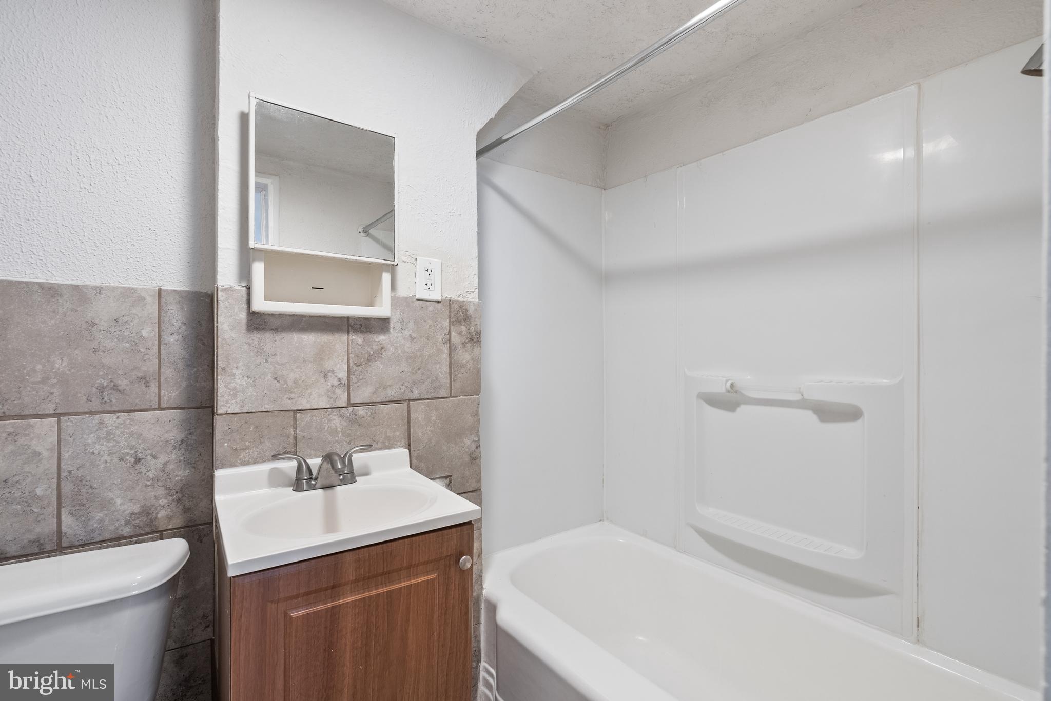 1617 Northwick Road Baltimore, MD 21218 - Photo 21 of 32 a bathroom with a sink toilet and shower