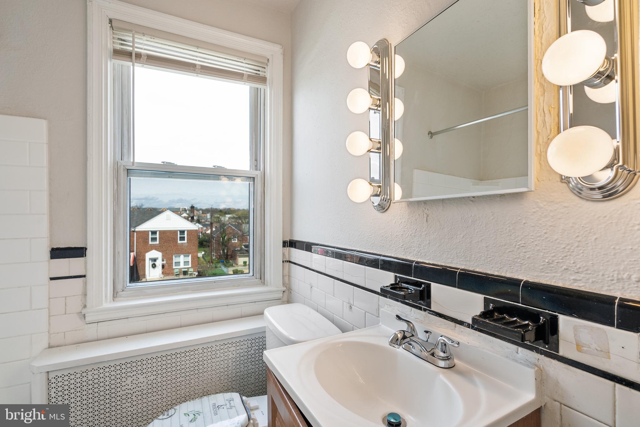 1617 Northwick Road Baltimore, MD 21218 - Photo 22 of 32 a bathroom with a sink and a mirror
