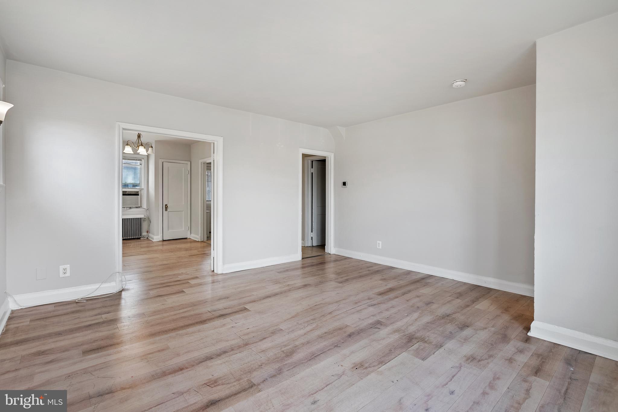 1617 Northwick Road Baltimore, MD 21218 - Photo 6 of 32 a view of an empty room with wooden floor and closet