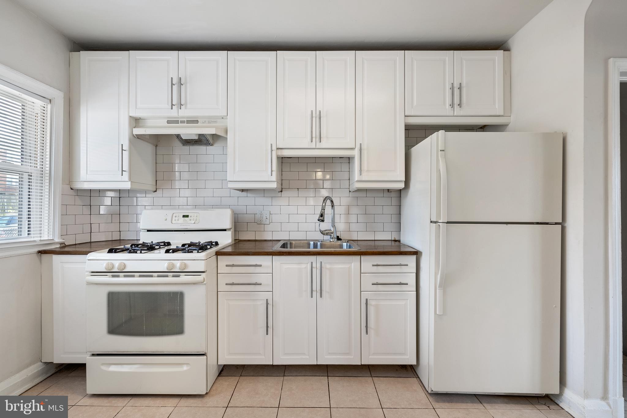 1617 Northwick Road Baltimore, MD 21218 - Photo 8 of 32 a kitchen with cabinets appliances and a sink